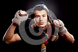 Young man holding a furry hat