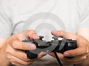 A young man holding game controller playing video games