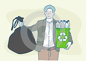 Young man holding a garbage bag and a recycling bin