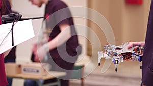 Young man holding his DIY hexapod robot. 4K shot