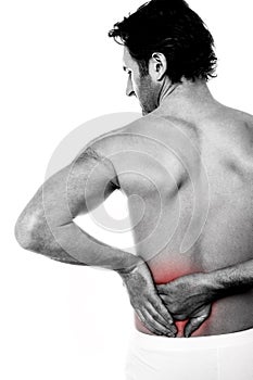 Young man holding his lower back in pain