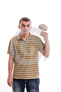 Young man holding a human brain model