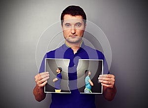 Young man holding the lacerated photo