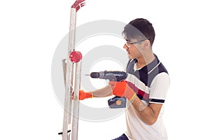 Young man holding ledder and electric screwdriver