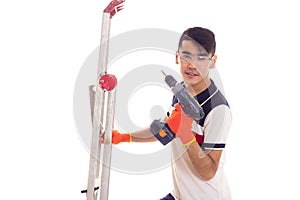 Young man holding ledder and electric screwdriver