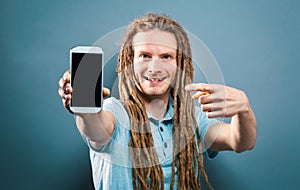 Young man holding out a cellphone