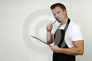 Young man holding paper clipboard on white