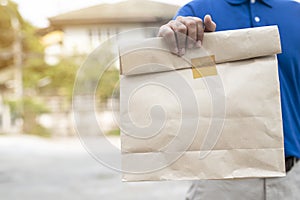 Young man holding paper containers for takeaway food