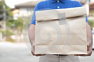 Young man holding paper containers for takeaway food