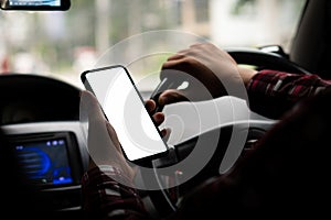 Young man holding a phone with white screen in a GPS routing concept car