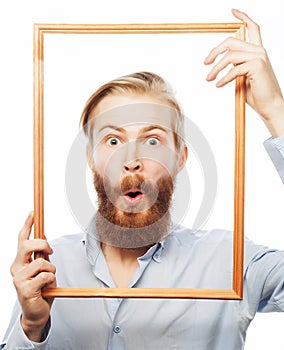 Young man holding picture frame