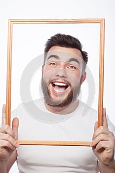 Young man holding picture frame