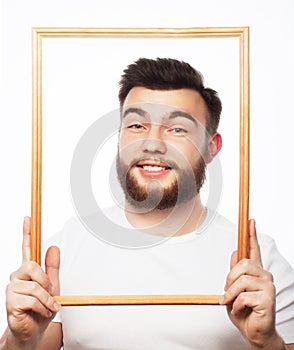 Young man holding picture frame