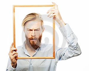 Young man holding picture frame