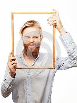 Young man holding picture frame