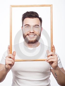 Young man holding picture frame