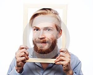 Young man holding picture frame