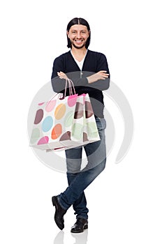 The young man holding plastic bags isolated on white