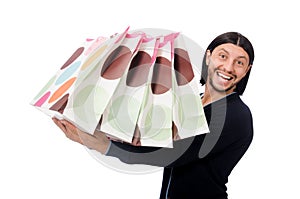 The young man holding plastic bags isolated on white