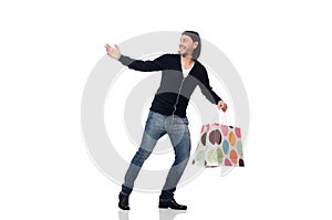 The young man holding plastic bags isolated on white