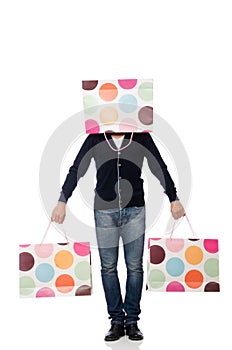 The young man holding plastic bags isolated on white