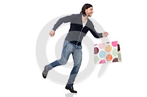 The young man holding plastic bags isolated on white