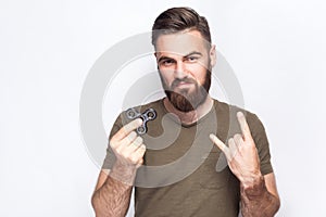 Young man holding and playing with fidget spinner.