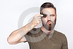 Young man holding and playing with fidget spinner.