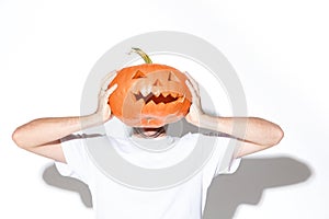 Young man holding pumpking on white background