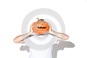 Young man holding pumpking on white background