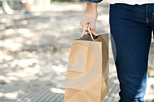 Young man holding shopping bag