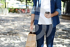 Young man holding shopping bag