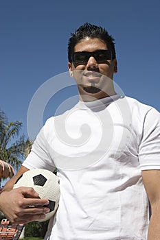 Young Man Holding Soccer Ball