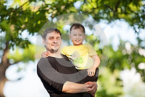 Young man holding son in Park