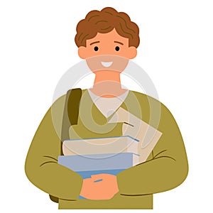 A young man is holding a stack of books and smiling