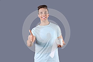 Young man holding toilet paper roll