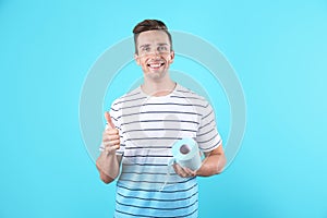 Young man holding toilet paper roll