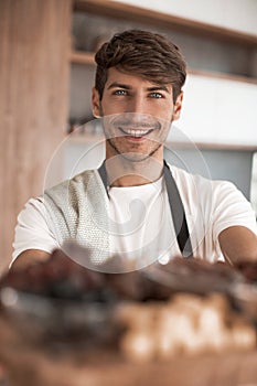 Young man holding a tray with a healthy Breakfast