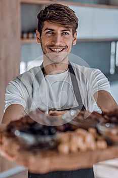 young man holding a tray with a healthy Breakfast