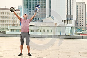 Young man holding two hoverboards.