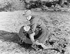 Young man holding an unconscious young woman