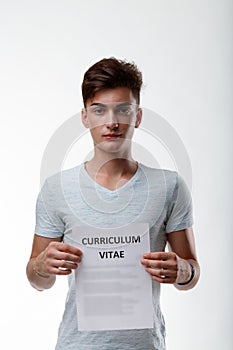 Young man holding up a sign with text - Curriculum Vitae