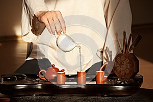 A young man holds a Chinese tea ceremony photo