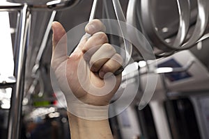 The young man holds the sling while traveling in the subway