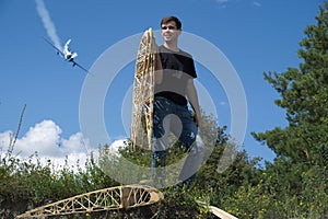 A young man holds the wing ribs.