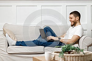 young man at home with laptop