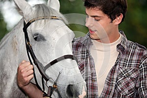 Young man with a horse photo