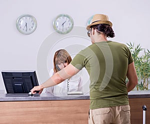 Young man at the hotel reception