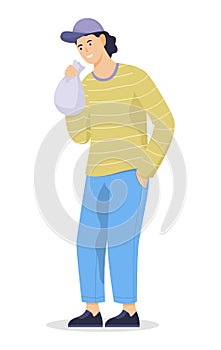 Young man huffing a bag with narcotic substances. Idea of drug addiction photo