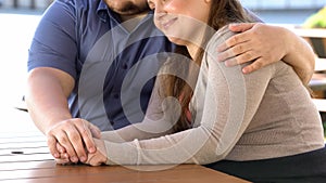 Young man hugging girlfriend sitting on bench, romantic date in park, fat couple